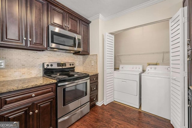 kitchen with dark hardwood / wood-style floors, independent washer and dryer, ornamental molding, appliances with stainless steel finishes, and light stone counters