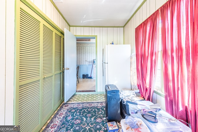 bedroom featuring white fridge, a closet, and carpet floors