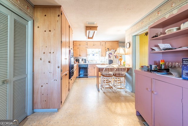 kitchen with dishwasher, white fridge, and a textured ceiling