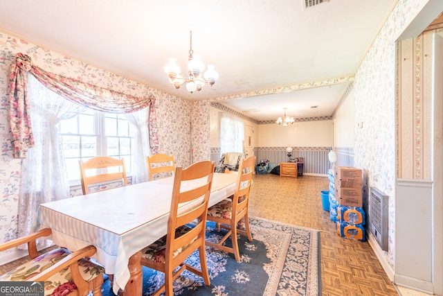 dining area with parquet floors and a chandelier