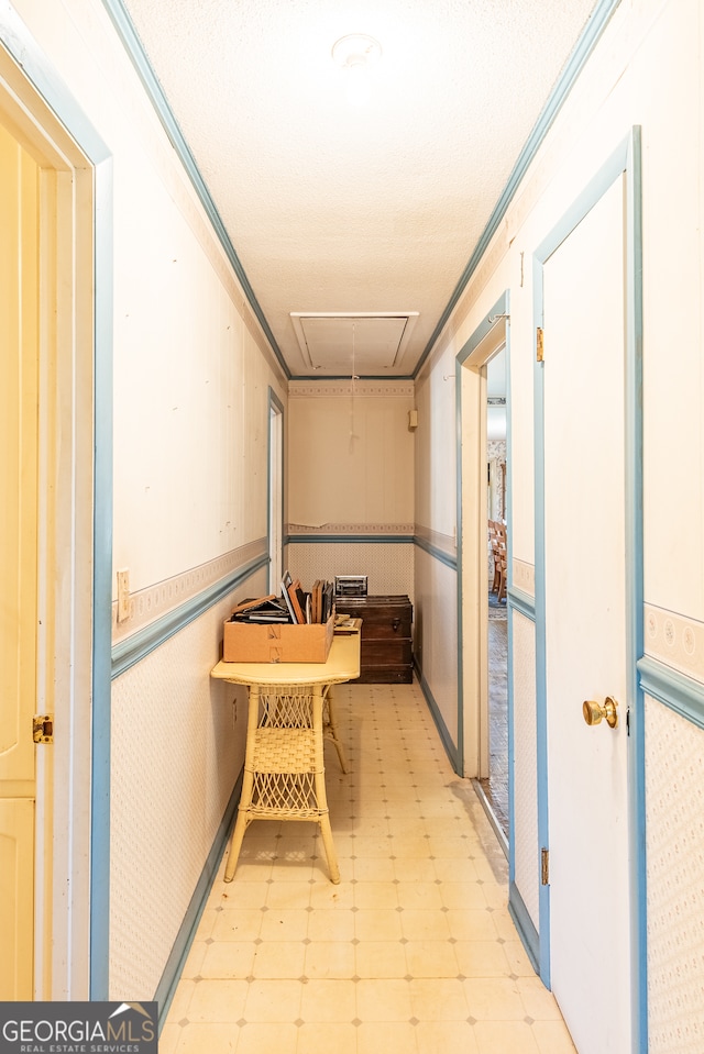 hallway featuring a textured ceiling