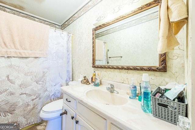 bathroom featuring vanity, ornamental molding, a textured ceiling, and toilet