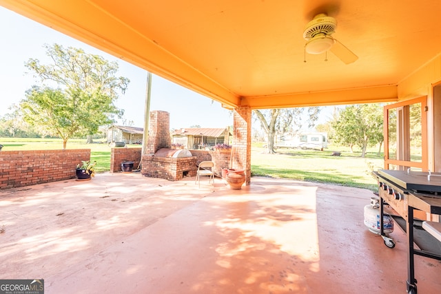 view of patio featuring an outdoor brick fireplace and ceiling fan