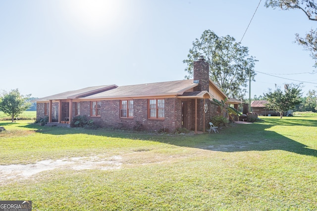 view of side of home featuring a lawn