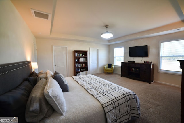 bedroom featuring carpet floors and multiple windows