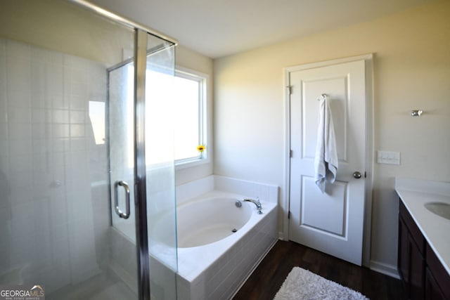 bathroom with vanity, plus walk in shower, and wood-type flooring