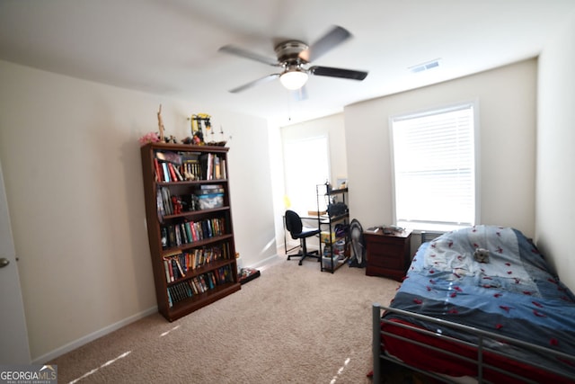 bedroom with ceiling fan and light carpet