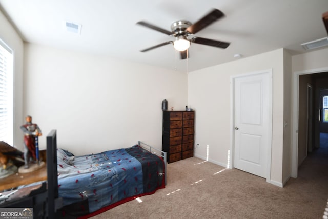 bedroom featuring ceiling fan and light colored carpet