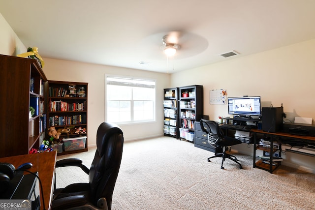 carpeted office featuring ceiling fan