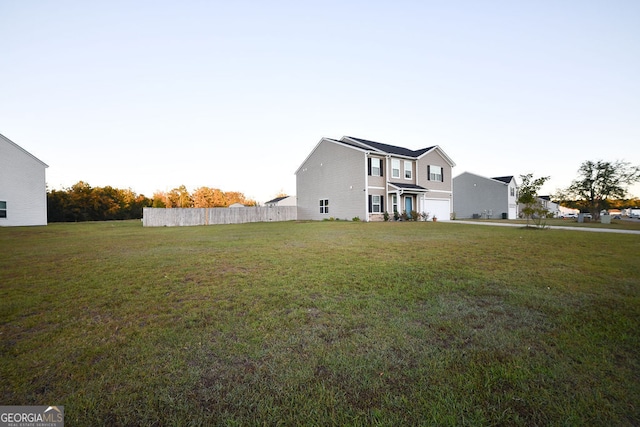 view of front of house featuring a garage and a front lawn