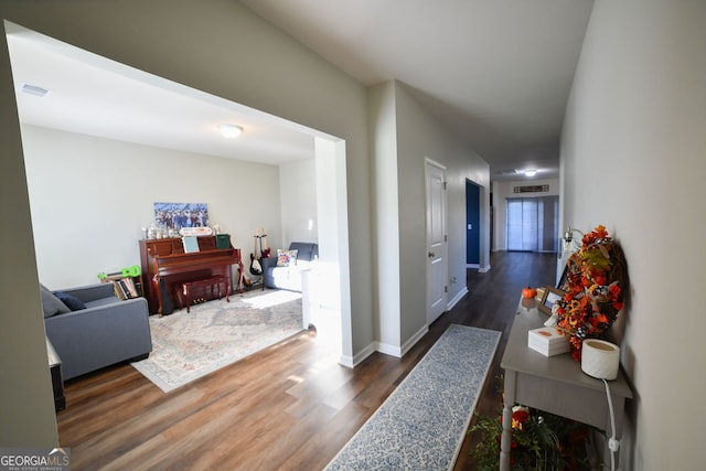 corridor with dark hardwood / wood-style flooring