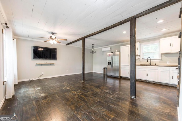 unfurnished living room featuring ornamental molding, sink, dark hardwood / wood-style floors, and ceiling fan