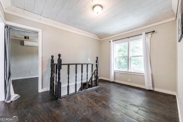 spare room featuring ornamental molding, wood ceiling, dark hardwood / wood-style floors, and a wall mounted air conditioner