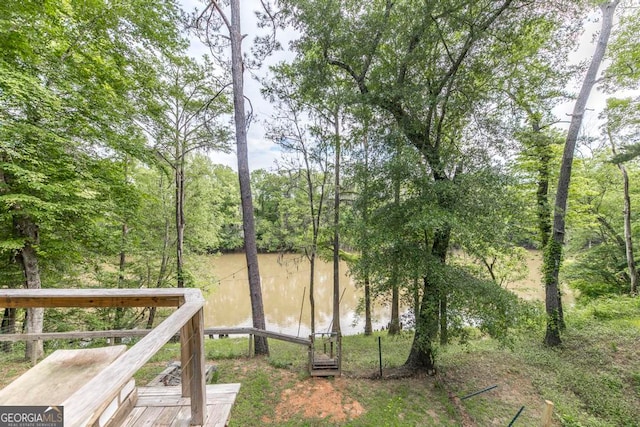 view of yard with a deck with water view