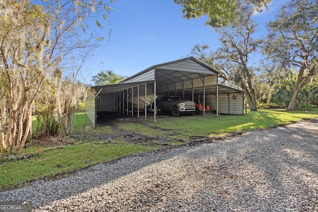 view of outdoor structure with a yard and a carport