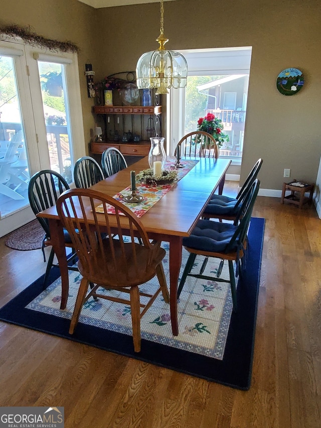 dining room with hardwood / wood-style floors and a chandelier