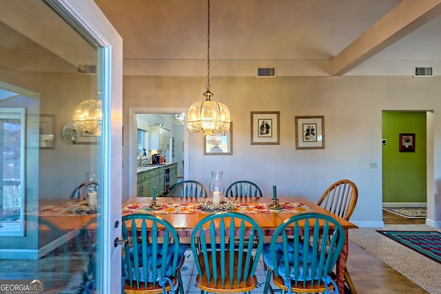 dining room featuring wood-type flooring and a chandelier