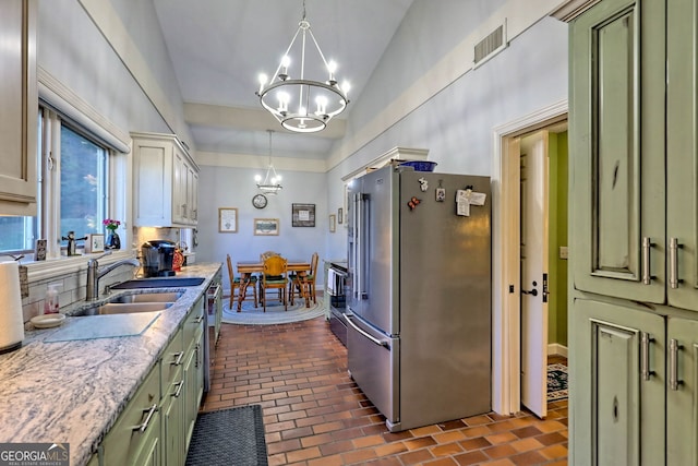 kitchen featuring decorative light fixtures, stainless steel appliances, sink, and green cabinetry