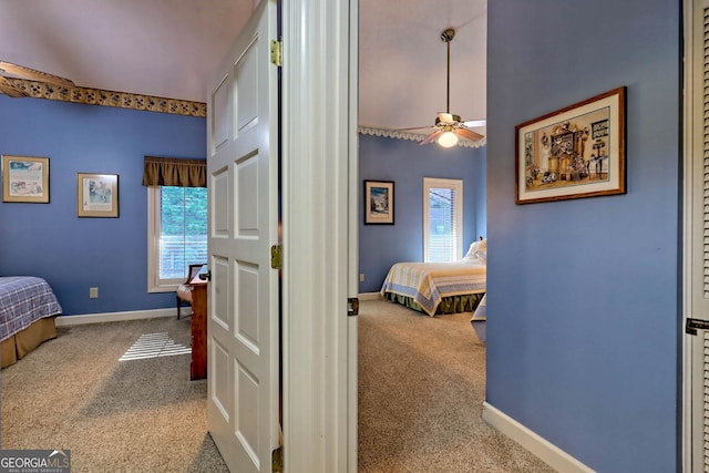 carpeted bedroom with multiple windows and ceiling fan