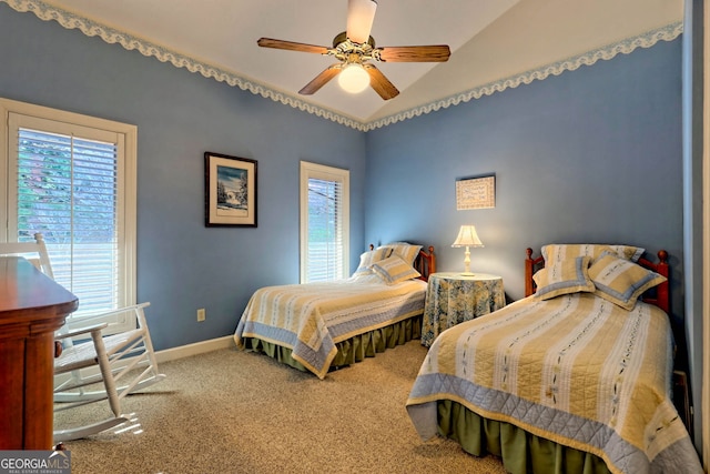 carpeted bedroom with ceiling fan and lofted ceiling