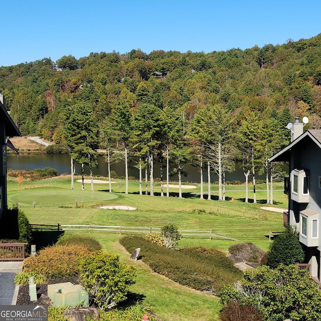 view of property's community featuring a water view and a lawn