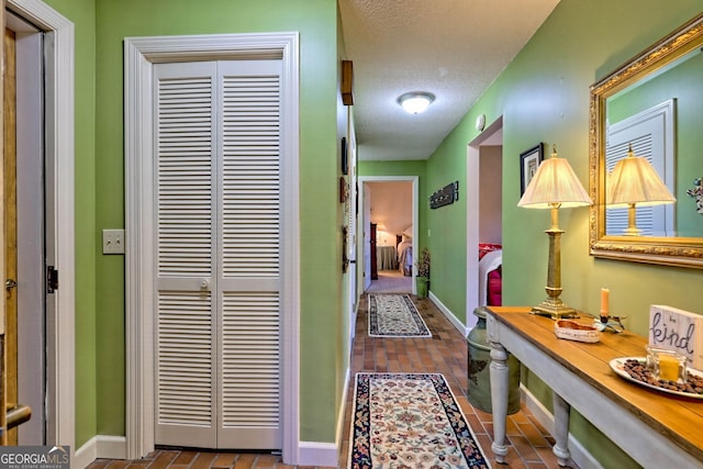 hall with a textured ceiling