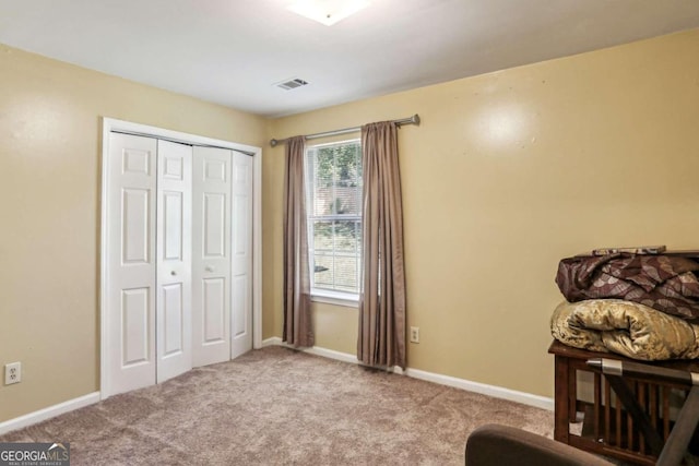 sitting room featuring light colored carpet