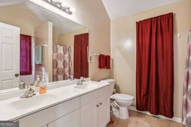 bathroom with vanity, toilet, lofted ceiling, and tile patterned flooring