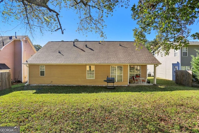 back of property featuring a patio and a lawn