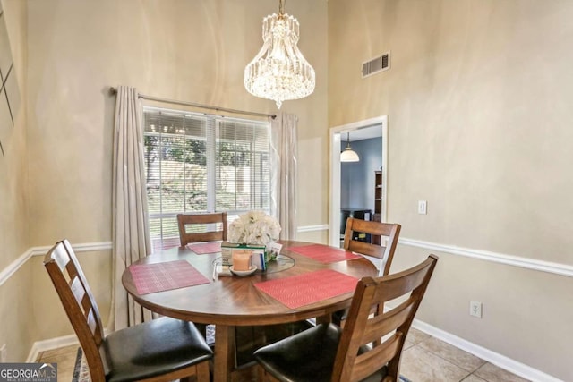 dining room featuring light tile patterned floors and a chandelier