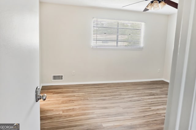 spare room with light hardwood / wood-style floors and ceiling fan