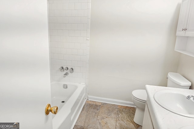 full bathroom featuring toilet, tiled shower / bath, and vanity