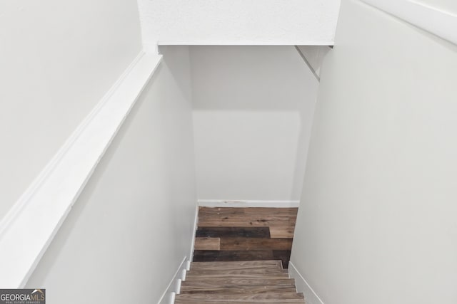 stairs featuring hardwood / wood-style flooring