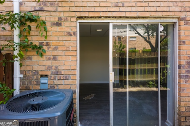 view of exterior entry featuring central AC unit