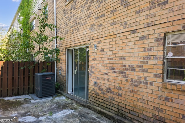 view of side of home with a patio area and central AC unit