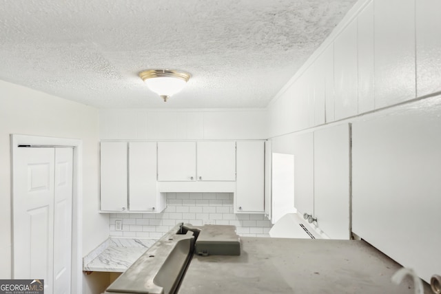 laundry room with a textured ceiling