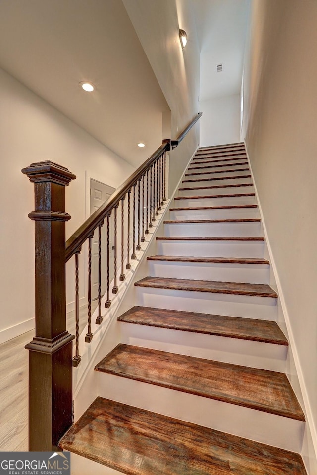 stairs with recessed lighting, baseboards, and wood finished floors