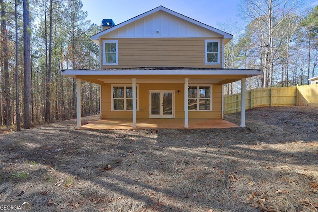 back of property with a patio, french doors, board and batten siding, and fence