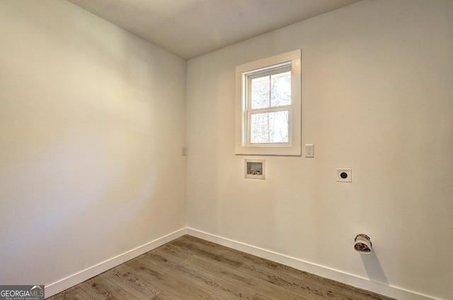 laundry room with hookup for a washing machine, electric dryer hookup, wood finished floors, laundry area, and baseboards