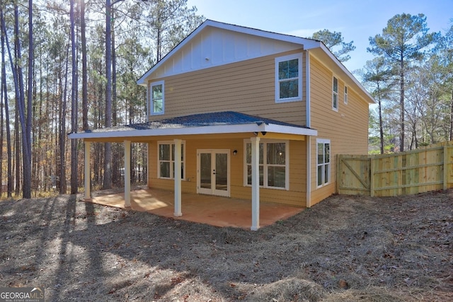 back of property featuring a patio area, fence, board and batten siding, and french doors