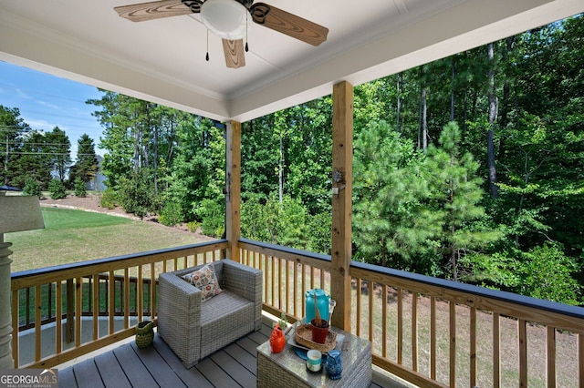 deck with ceiling fan and a yard