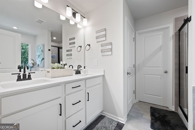 bathroom with vanity and a shower with shower door