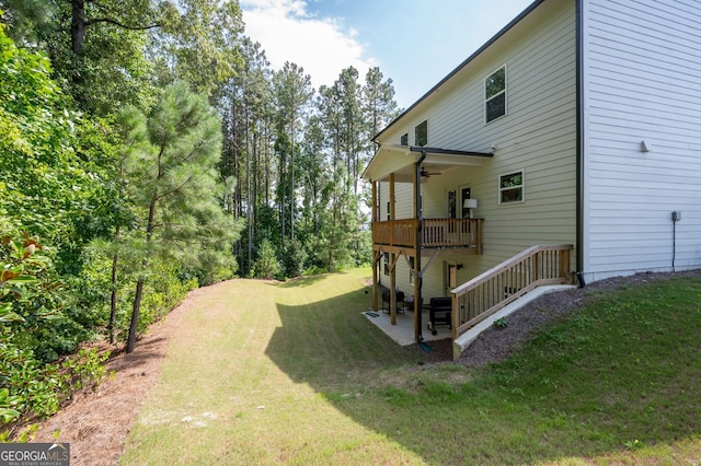 view of yard featuring a patio area and ceiling fan