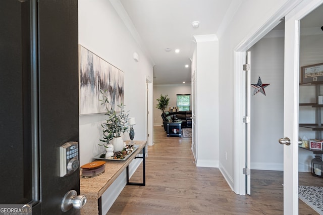 hall featuring crown molding and light wood-type flooring