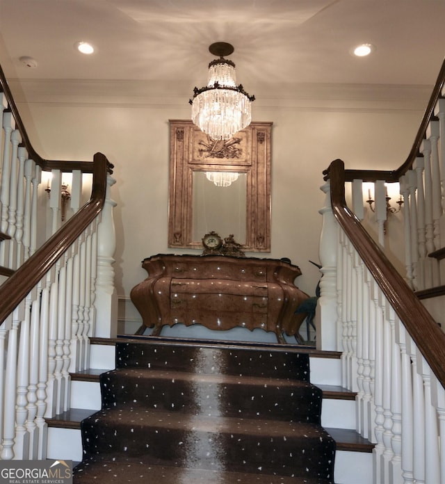 stairway with a notable chandelier and crown molding