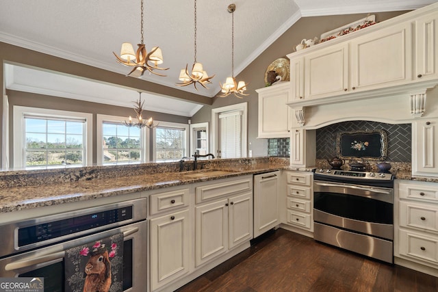 kitchen with lofted ceiling, backsplash, hanging light fixtures, appliances with stainless steel finishes, and stone countertops