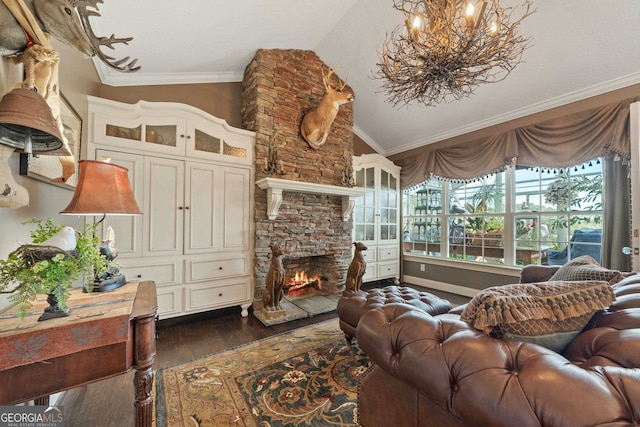 living room featuring dark hardwood / wood-style floors, a stone fireplace, crown molding, and vaulted ceiling