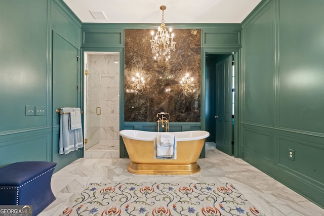 bathroom featuring an inviting chandelier and separate shower and tub