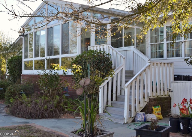 view of property exterior with a sunroom