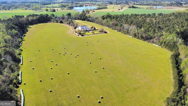 birds eye view of property featuring a rural view and a water view